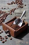 Ground coffee beans in a drawer belonging to an old coffee mill