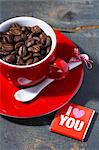 An espresso cup filled with coffee beans