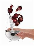 Washing beetroot in a sieve