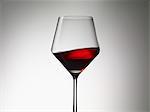 Red wine sloshing in a wine glass