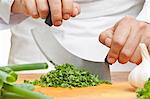 Chopping curly parsley with a mezzaluna knife