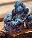 Ice cubes with blueberries on a wooden table