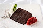 Slice of Chocolate Layer Cake with Sliced Strawberry and Whipped Cream