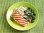 Grilled Salmon with Rice and Spinach Salad with Sliced Radish and Almonds; On a Green Plate