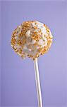 A cake pop with golden sprinkles