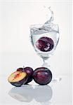 A damson falling into a schnapps glass