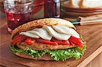 Grilled Chicken Breast Sandwich with Roasted Red Peppers, Mozzarella Cheese and Lettuce on Grilled Tuscan Boule Bread