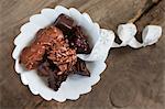 A bowl of Christmas confectionery with a ribbon