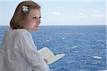 Teenage Girl Reading Book on Cruise Ship