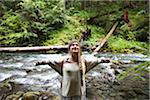 Young Woman with Outstretched Arms Beside River