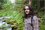 Portrait of Man Standing Next to River