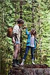 Two Teenagers Playing on Tree Trunk