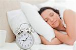 Alarm clock with a woman sleeping