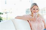 Woman in pink shirt drinking water