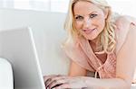 Woman in pink shirt tapping on her laptop