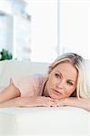 Close-up of a cute pink shirt woman lying on her sofa