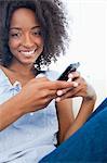 Portrait of a smiling fuzzy hair woman with a smartphone