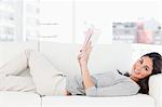 Portrait of a brunette lying on her sofa