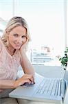 Portrait of a smiling blonde on a laptop