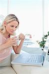 Blonde on a laptop with a coffee