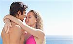 Side view of lovely couple embracing in the pool