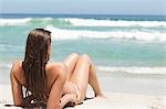 Woman sunbathing on the sand