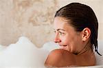 Smiling woman sitting in the tub