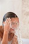 Woman in the tub washing her face