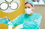 Concentrated female surgeon wearing a mask