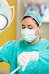 Concentrated female surgeon using surgical tools