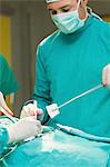 Close up of surgeons holding surgical tools