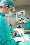 Close up of a male surgeon using scissors