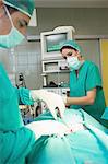 Close up of a male surgeon using surgical scissors