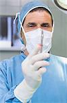 Male surgeon holding a scalpel in his hand