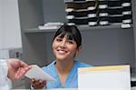 Nurse smiling while holding a paper