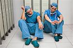 Two surgeons sitting in a locker room