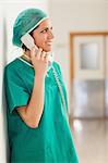 Woman surgeon holding a telephone in a hallway