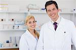 Two pharmacists standing behind a counter