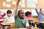 Young pupils raising their hands