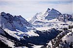 A winter view of the Maroon Bells mountain peaks in Colorado from a nearby mountain.