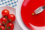 Directly above photograph of red tomatoes and a green pea.