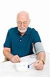 Senior man using a home blood pressure machine to check his vital statistics.  White background.