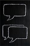 Chalk drawing of speech bubbles on a blackboard