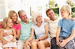 Extended Family Relaxing Together On Sofa