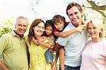 Extended Group Portrait Of Family Enjoying Day In Park