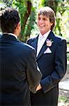 Handsome groom marries his life partner in an outdoor wedding ceremony.