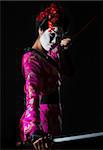 Portrait of geisha holding sword isolated on black