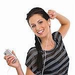 Portrait of happy girl listening music in headphones and dancing