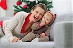 Smiling young mother and baby having fun time on Christmas