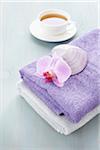 Cup of Tea and Stack of Towels with Seashell and Orchid
